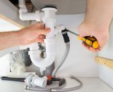 Close-up Of A Male Plumber Repairing Sink In Bathroom
